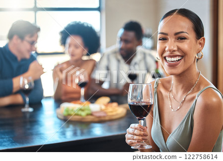 Social, happy and wine of a woman with a glass of alcohol at a dinner table with friends in a restaurant. Young female with smile in luxury fun dining with people at a celebration or event indoors. Social, happy and wine of a woman with a glass of alcohol at a dinner table with friends in a restaurant. Young female with smile in luxury fun dining with people at a celebration or event indoors. 122758614