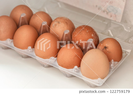 White mould on eggs that have been stored in wet fridge for long time 122759179