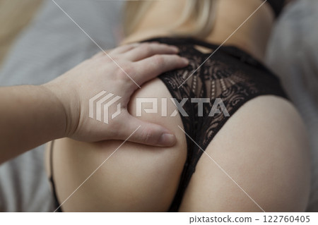 foreplay and sex. Man's hand caressing woman's buttocks 122760405