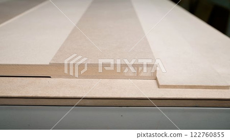 Wooden door, production of interior doors. The door lies on the packing table. Wooden door blank, in production. Wooden door, production of interior doors. The door lies on the packing table. Wooden door blank, in production. 122760855