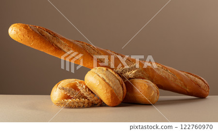 Baguette and French buns on a beige background. 122760970