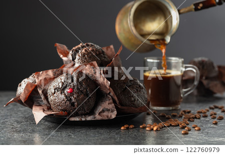 Dark chocolate muffins and cup of black coffee. Dark chocolate muffins and cup of black coffee. 122760979