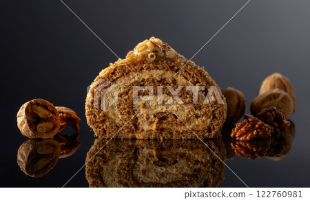 Dessert with walnuts on a black reflective background. Dessert with walnuts on a black reflective background. 122760981