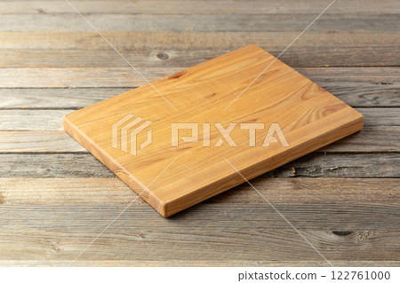 Cutting board on a wooden table. Cutting board on a wooden table. 122761000