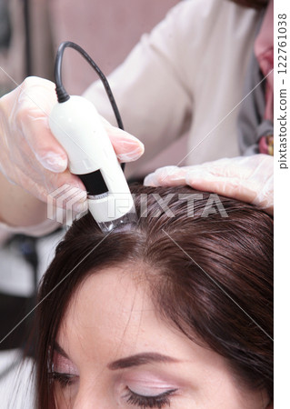 Doctor examine patient female hair special apparatus and computer. Diagnostics hair and scalp. Trichoscopy. 122761038