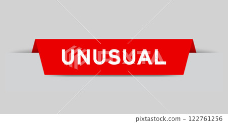 Red color inserted label with word unusual on gray background Red color inserted label with word unusual on gray background 122761256