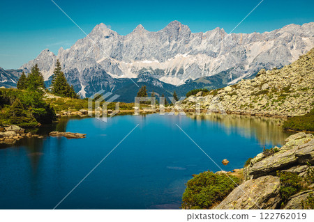 Clean alpine lake and high mountain ridges in Austria 122762019