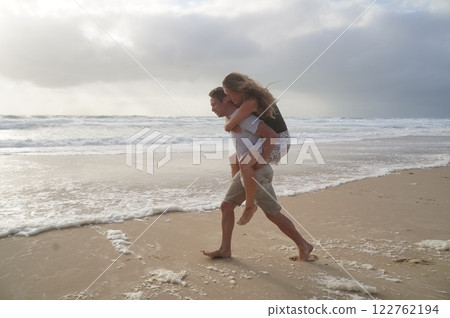 Loving couple playing on ocean beach 122762194