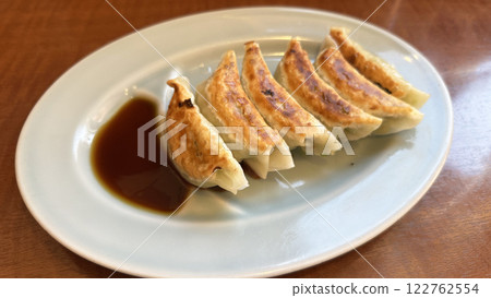 Gyoza with sauce spilled over the back Gyoza with sauce spilled over the back 122762554