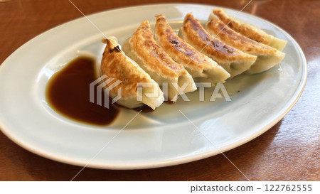 Gyoza with sauce spilled over the back Gyoza with sauce spilled over the back 122762555