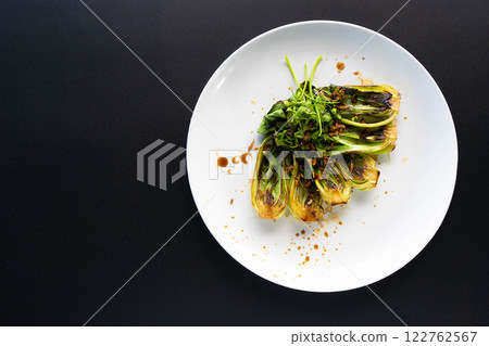Grilled bok choy arranged elegantly on a plate features vibrant flavors and textures. Grilled bok choy arranged elegantly on a plate features vibrant flavors and textures. 122762567