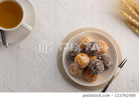 Kanom Kai Hong, a kind of Thai dessert made from rice flour Stuffed with Mung Bean and coated with sugar.Thai snack food (Swan Eggs Dessert).Top view with copy space. 122762980