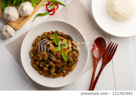 Stir fried green mussel with thai holy basil in white plate.Thai spicy food.Top view. 122762983