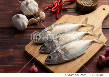 Raw fresh mackerel fish (short bodied mackerel ) on cutting board.Fresh seafood ingredients. 122763015