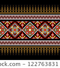Indian ethnic tribal fabric pattern featuring intricate floral designs in red and yellow tones. The bold contrast against a black background  ethnic enhances the vibrancy, ethnic artistic edging adds  122763831