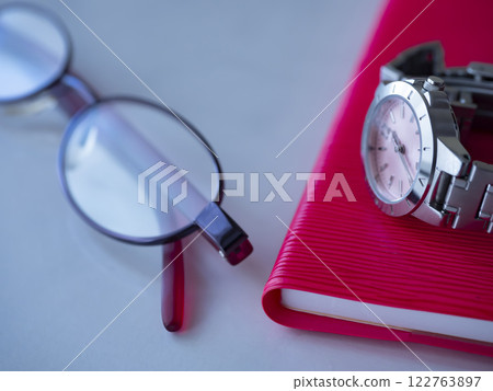 Notebook, glasses and watch on the table 122763897