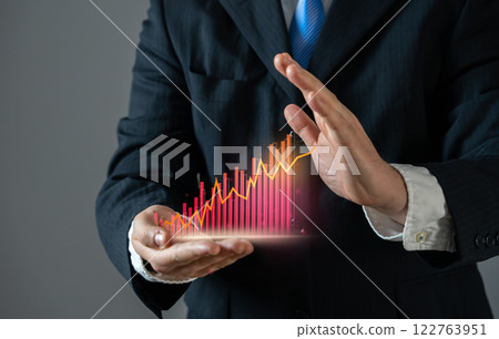 Businessman tries to stop the growth of the red graph. Indicator of high expenses, growth of crime or corruption, other negative news. Rising expenses, economic downturn, financial losses, inflation 122763951