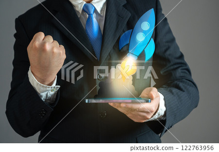 Businessman excited about rocket launch, startup concept. Entrepreneurship, launching new projects, ambition, market expansion, and financial breakthroughs. 122763956