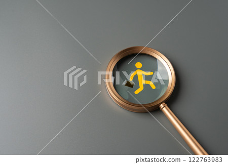 Magnifying glass and running man with briefcase in focus. Migration of labor. Flight of businesses and investors. Corporate relocation, skilled worker shortages. Talent search in job markets. 122763983