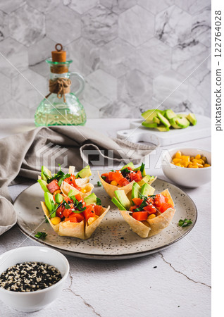 Mini poke bowls in pita bread on a plate on the table vertical view Mini poke bowls in pita bread on a plate on the table vertical view 122764028