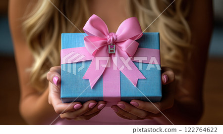 Woman hands holding blue gift satin ribbon, shopping Valentines, New Year, Mothers, Christmas 122764622