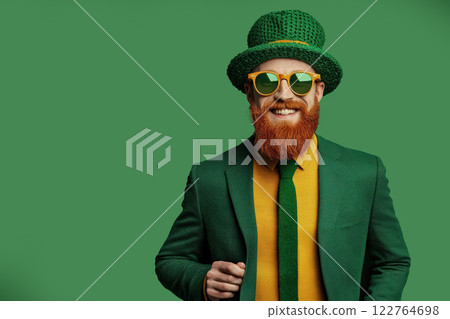 Man hat green traditional Irish attire holding Happy St. Patrick's Day sign, copy space 122764698
