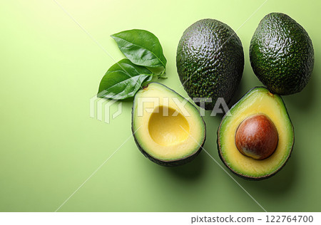 Flat Lay avocados, leaves green, sliced, top view avocado leaves, space text, vegetarian, vitamin Flat Lay avocados, leaves green, sliced, top view avocado leaves, space text, vegetarian, vitamin 122764700
