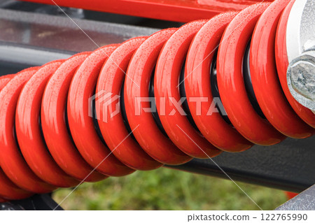 Steel red spring as part of agricultural machine. Technology 122765990