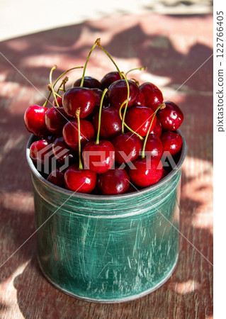 Fresh cherries straight from the garden, in green dishes, a healthy eating concept Fresh cherries straight from the garden, in green dishes, a healthy eating concept 122766405