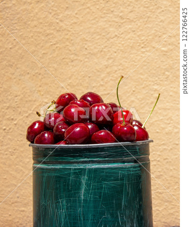 Fresh cherries on a peach background, a healthy eating concept, with space for text 122766425