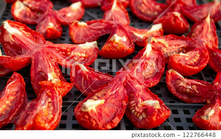The process of drying tomatoes outdoors for seasoning, for cooking for cooking various dishes The process of drying tomatoes outdoors for seasoning, for cooking for cooking various dishes 122766448
