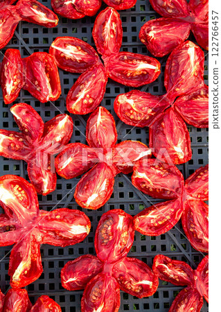 The process of drying tomatoes outdoors for seasoning, for cooking for cooking various dishes The process of drying tomatoes outdoors for seasoning, for cooking for cooking various dishes 122766457