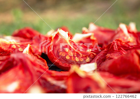 The process of drying tomatoes outdoors for seasoning, for cooking for cooking various dishes The process of drying tomatoes outdoors for seasoning, for cooking for cooking various dishes 122766462