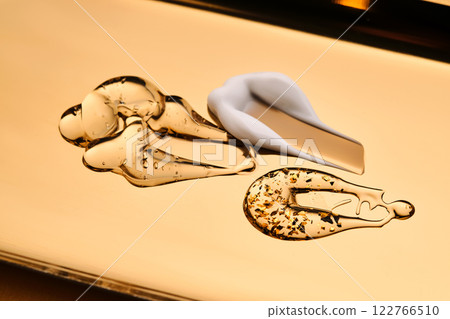 Textures of different cosmetic products on a gold background. 122766510