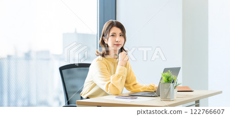 Smiling woman/businesswoman doing desk work Smiling woman/businesswoman doing desk work 122766607