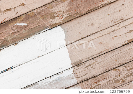 Old wooden wall with white and pink painted parts 122766799