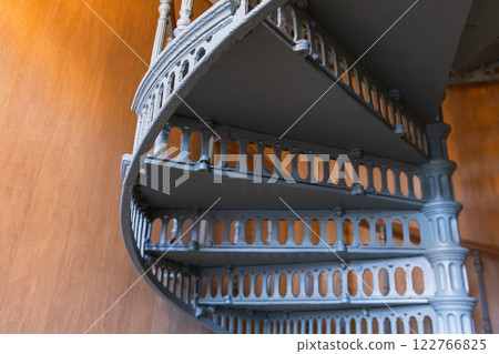Stairs of a spiral staircase made of cast iron painted in gray Stairs of a spiral staircase made of cast iron painted in gray 122766825