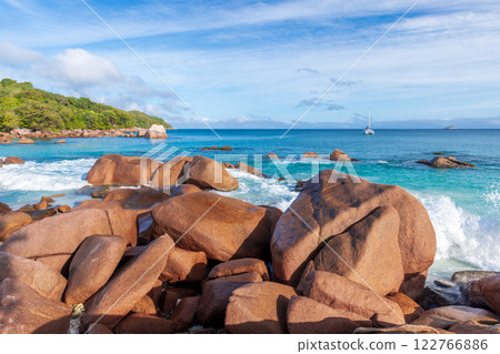 Coastal rocks and shore water of Anse Lazio beach on a sunny day Coastal rocks and shore water of Anse Lazio beach on a sunny day 122766886