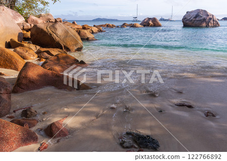 Shore water and wet sand of Anse Lazio beach on a sunny day Shore water and wet sand of Anse Lazio beach on a sunny day 122766892