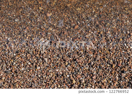 Coarse wet sand on the beach. Natural photo with selective focus Coarse wet sand on the beach. Natural photo with selective focus 122766952