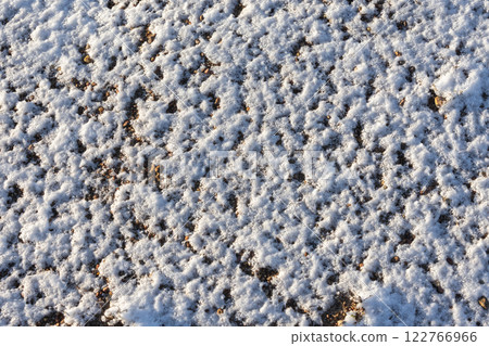 Frozen beach ground pattern, sand covered with snow, top view 122766966