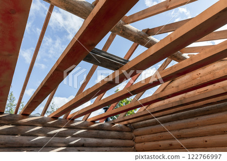 A log house is under construction. New wooden house without roof 122766997