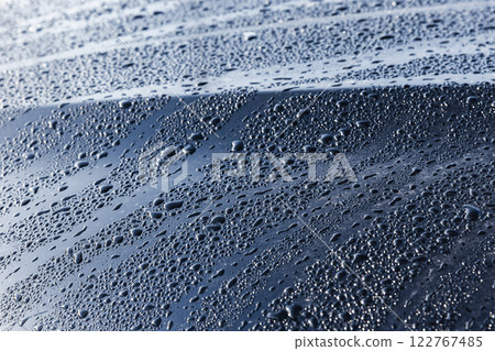 Abstract background. Water drops are on black car hood, close up Abstract background. Water drops are on black car hood, close up 122767485