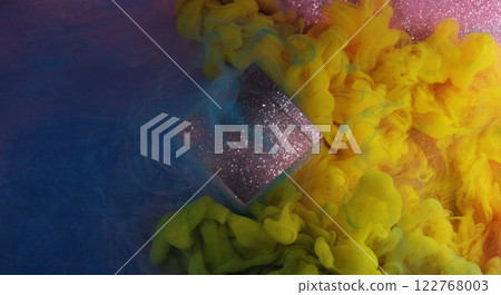 Blending colors. Paint spill. Bright blue yellow pink flow smoke glitter cube cloud ink texture on purple shimmering art background. Blending colors. Paint spill. Bright blue yellow pink flow smoke glitter cube cloud ink texture on purple shimmering art background. 122768003