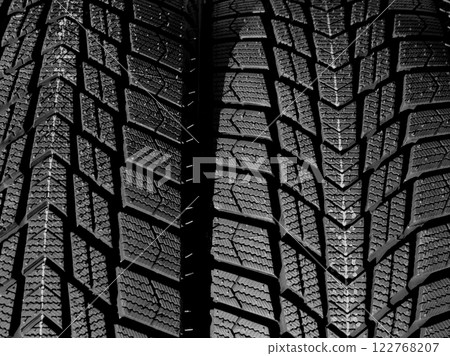 Directional design of the tread of car tires turned in different side of rotation. Textured pattern of directional tread blocks on a car tire Directional design of the tread of car tires turned in different side of rotation. Textured pattern of directional tread blocks on a car tire 122768207