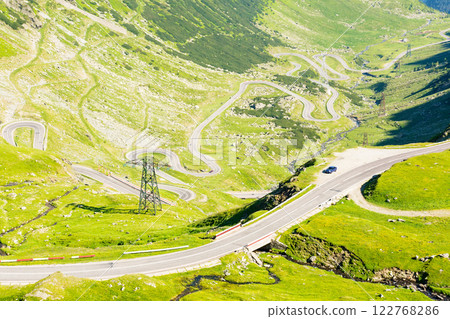 transfagarasan road winding uphill. outdoor adventure. travel destination in romania mountain landscape. sunny day in summer. view in to the valley. famous roadway transfagarasan road winding uphill. outdoor adventure. travel destination in romania mountain landscape. sunny day in summer. view in to the valley. famous roadway 122768286