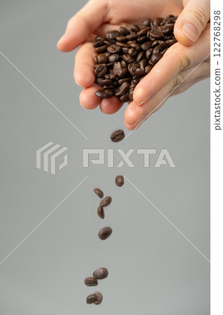 Hands Pouring Decaffeinated Coffee Beans 122768298