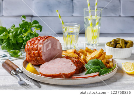boneless smoked ham with fried potatoes on plate 122768826
