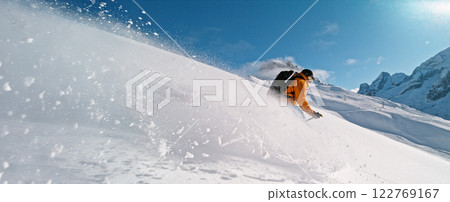 Extreme skier riding in powder snow and doing turns. 122769167