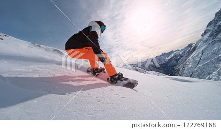 Extreme snowboarder riding in powder snow and doing turns. 122769168
